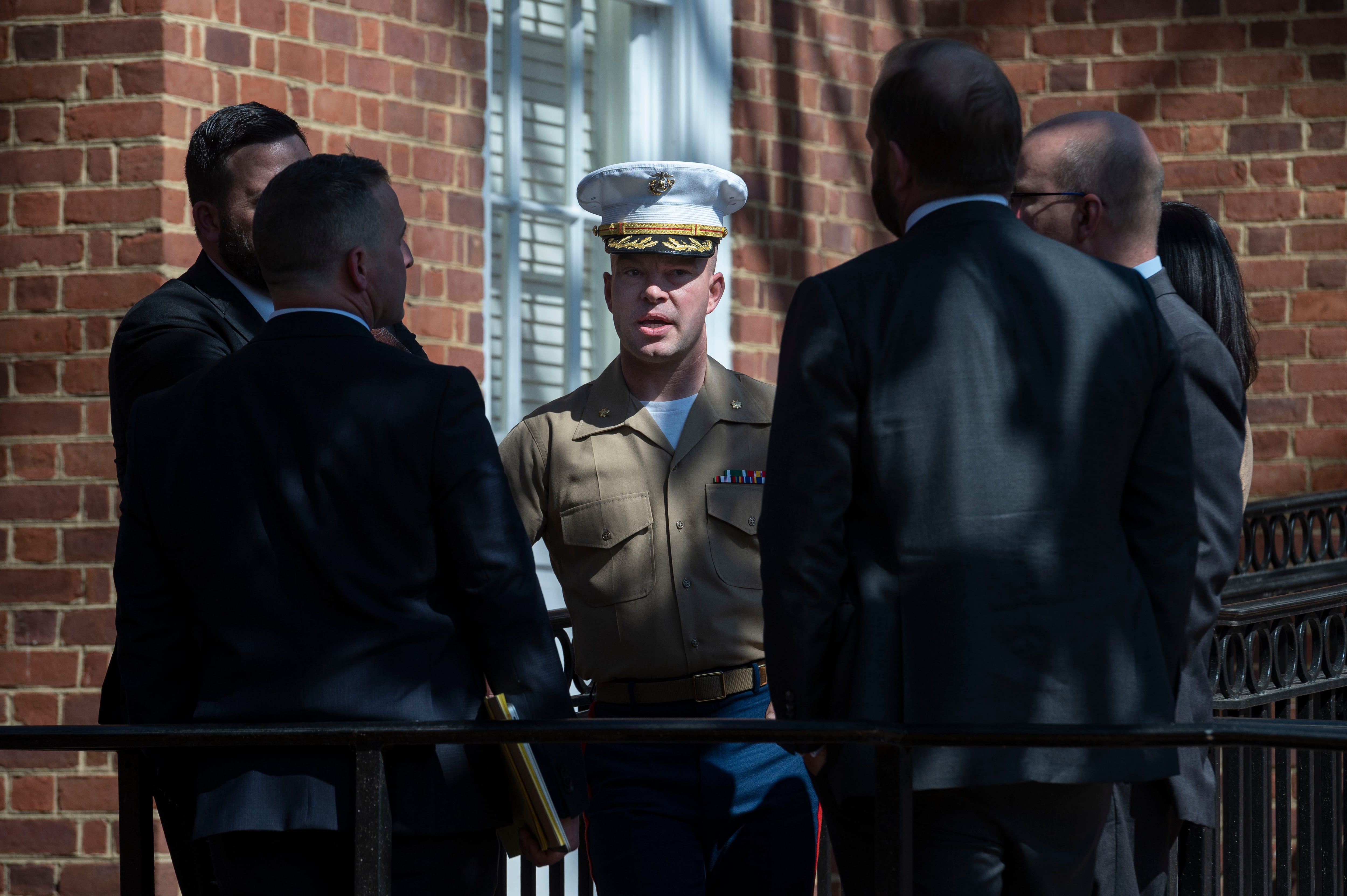 U.S. Marine Corps Major Joshua Mast, center, talks with his attorneys during a break in the hearing in an ongoing custody battle over an Afghan orphan, at the Circuit Courthouse in Charlottesville, Va., Thursday, March 30, 2023.