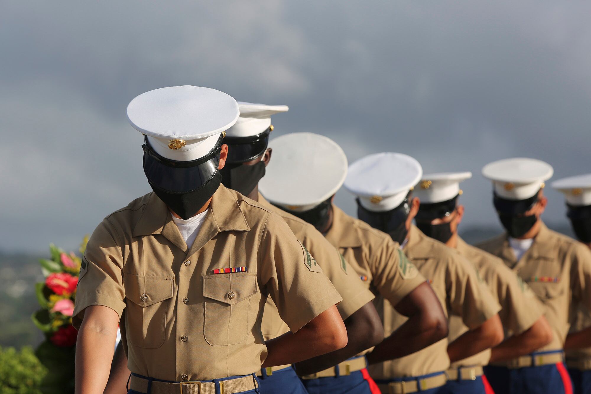 Marines wearing masks pause during a prayer at a ceremony marking the attack on Pearl Harbor, Monday, Dec. 7, 2020, in Pearl Harbor, Hawaii.