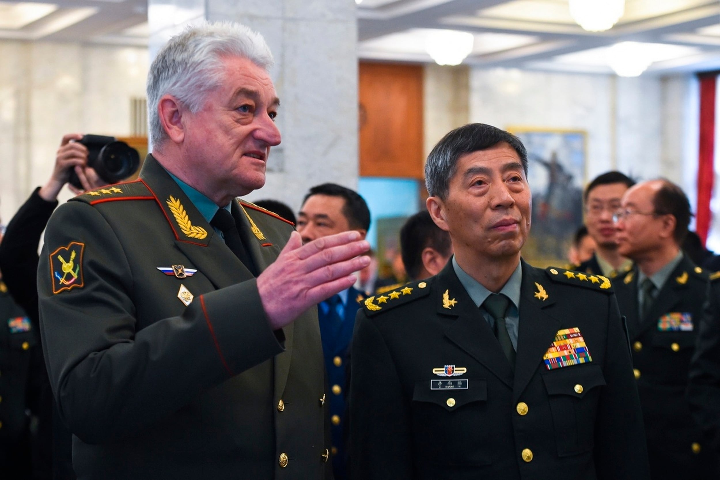 In this handout photo released by Russian Defense Ministry Press Service, Chief of the Military Academy of the General Staff of the Armed Forces of the Russian Federation Col. Gen. Vladimir Zarudnitsky, left, escorts China's Defense Minister Gen. Li Shangfu during a visit to Military Academy of the General Staff of the Armed Forces of the Russian Federation in Moscow, Russia, Monday, April 17, 2023.