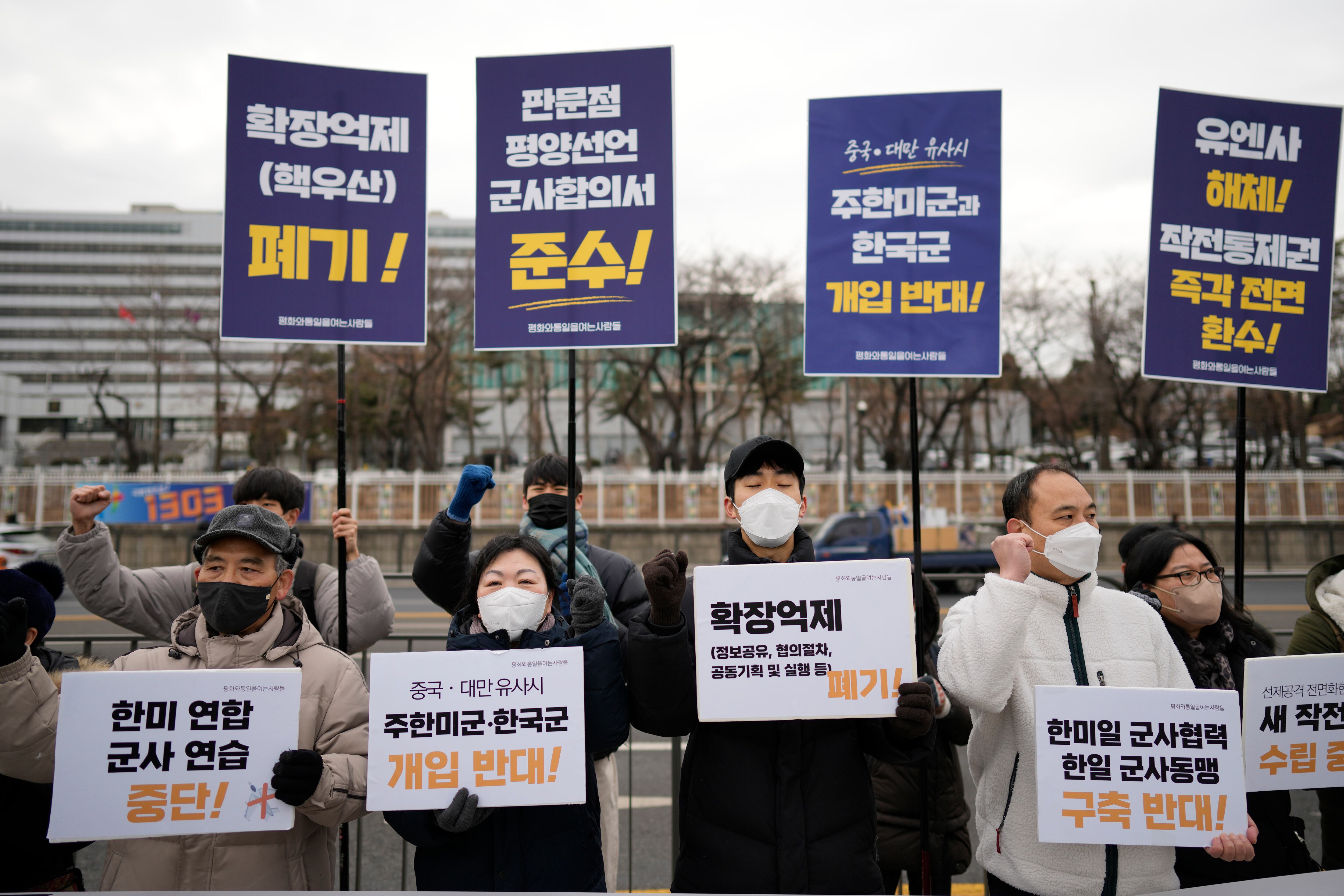 Protesters shout slogans during a rally outside of Defense Ministry, the venue for the meeting between U.S. Secretary of Defense Lloyd Austin and his South Korean counterpart Lee Jong-sup, in Seoul, South Korea, Tuesday, Jan. 31, 2023. A part of letters read "Stop the joint military exercise between the U.S. and South Korea."