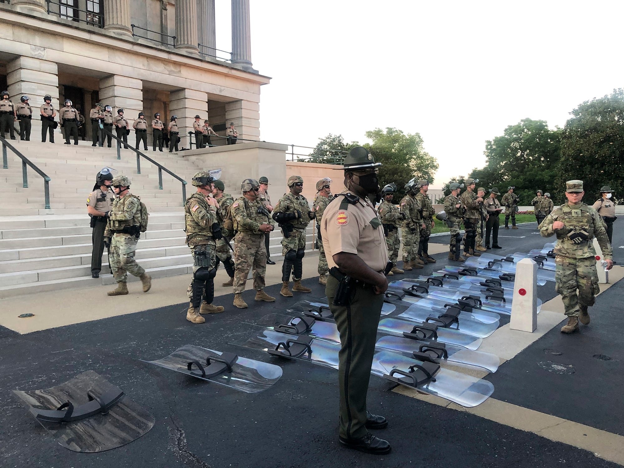 National Guard troops lay down their shields at the request of protesters in Nashville, Tenn., Monday, June 1, 2020.